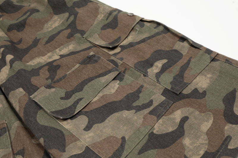 Close-up of back cargo pockets on green brown camouflage shorts