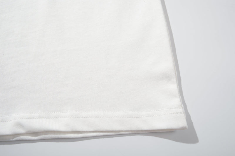 Close-up of a white polo shirt hem with neat stitching and soft cotton texture on a clean background