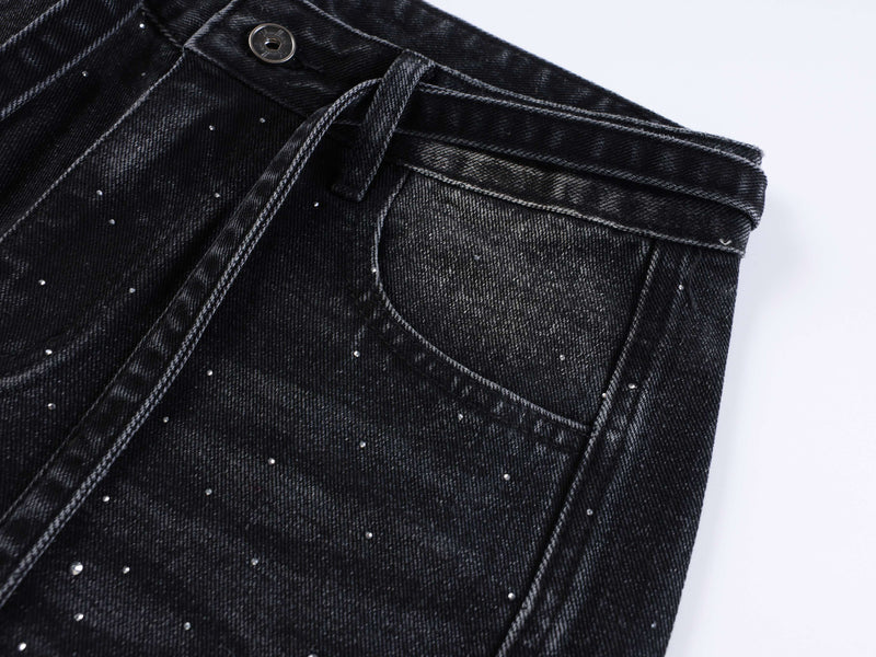Black denim front waist close-up with button, belt tie, and front pocket