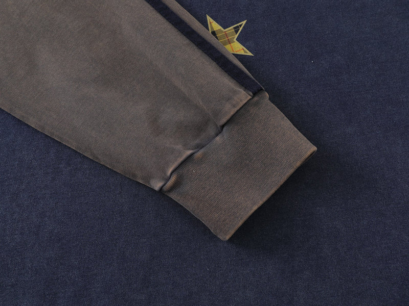 Close-up of tan sleeve cuff on blue raglan long sleeve tee