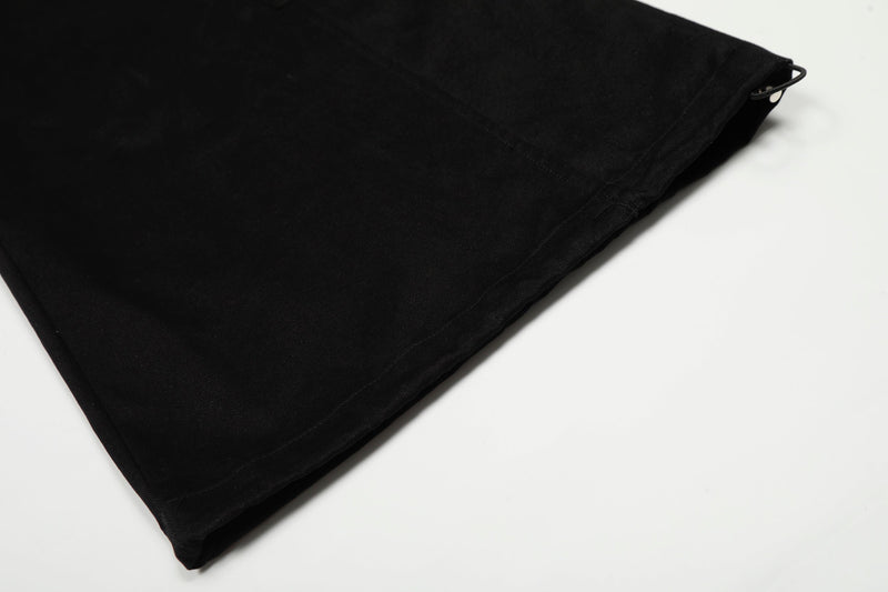Black pants hem with side zipper pull and stitched cuff detail