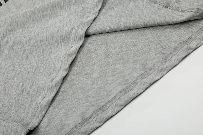 Close-up of gray tee hem and stitching