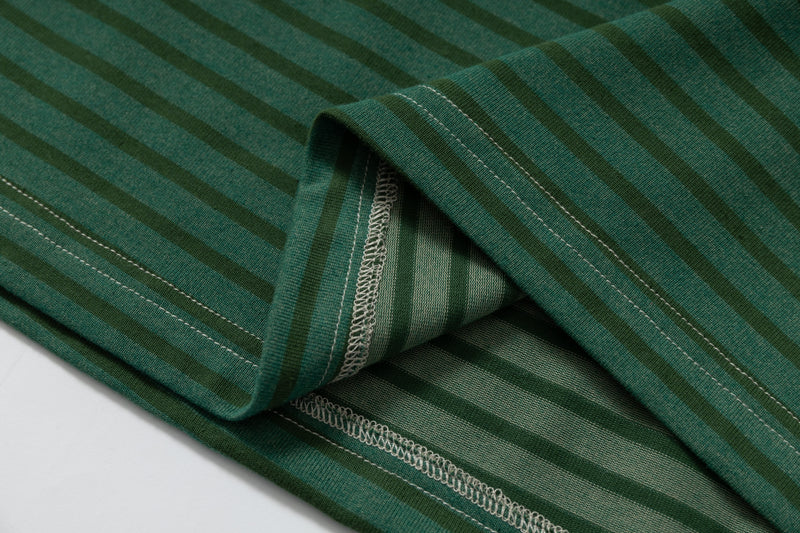 Close-up of green striped sleeve with layered cuff and stitching