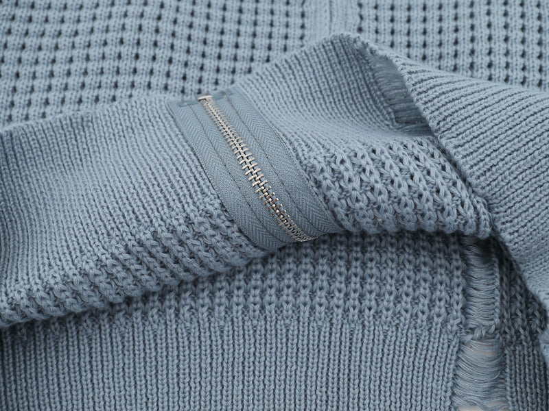 Close-up of light blue cardigan sleeve zipper and knit texture