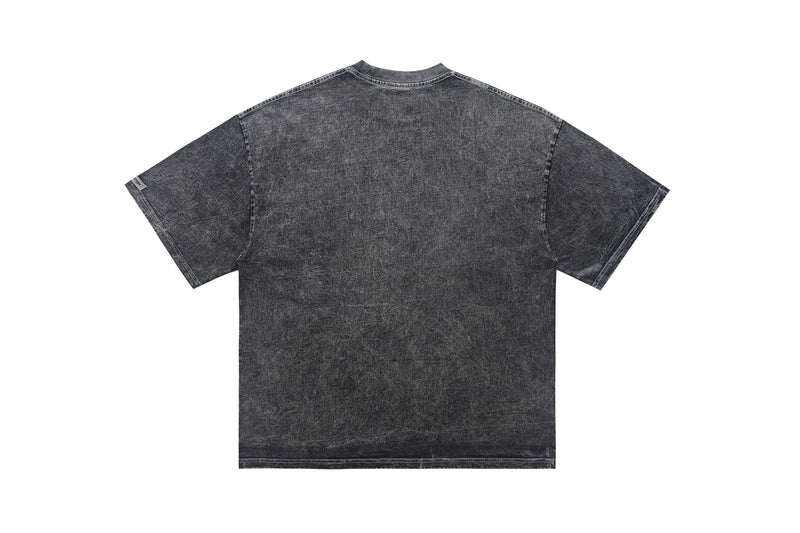 Vintage wash black graphic tee shown from the back with a faded, distressed denim-like finish and oversized fit