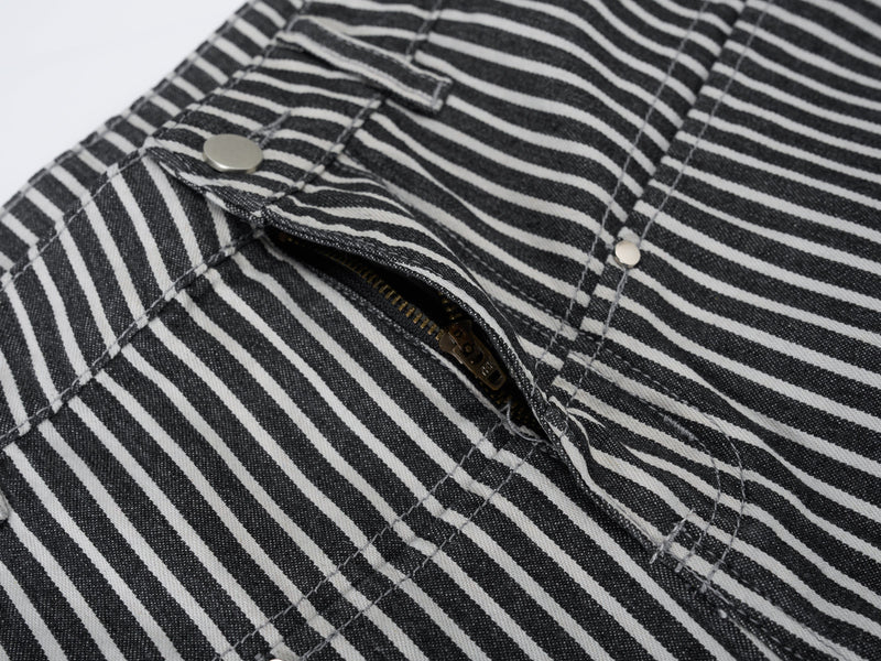 Close-up of striped jeans fly area with zipper and front snap closure