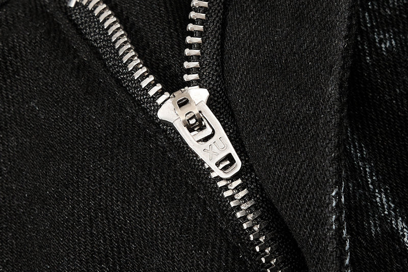 Close-up of silver zipper pull on black washed cargo denim