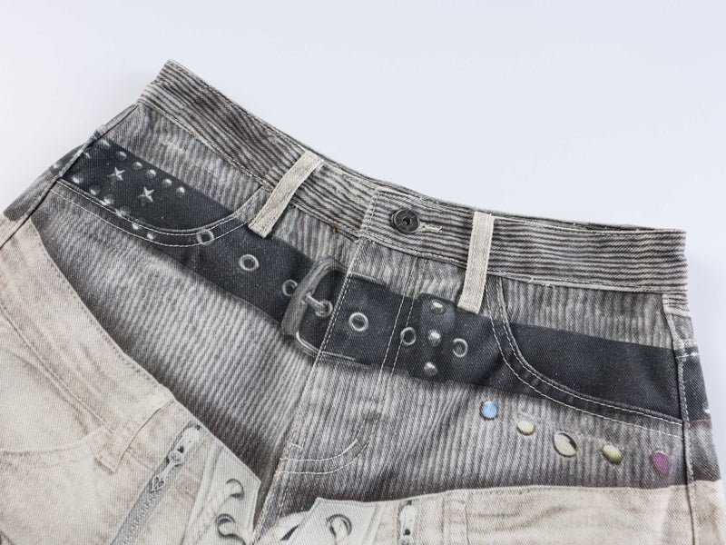 Angled close-up of waistband and printed denim panel with star and circle pattern