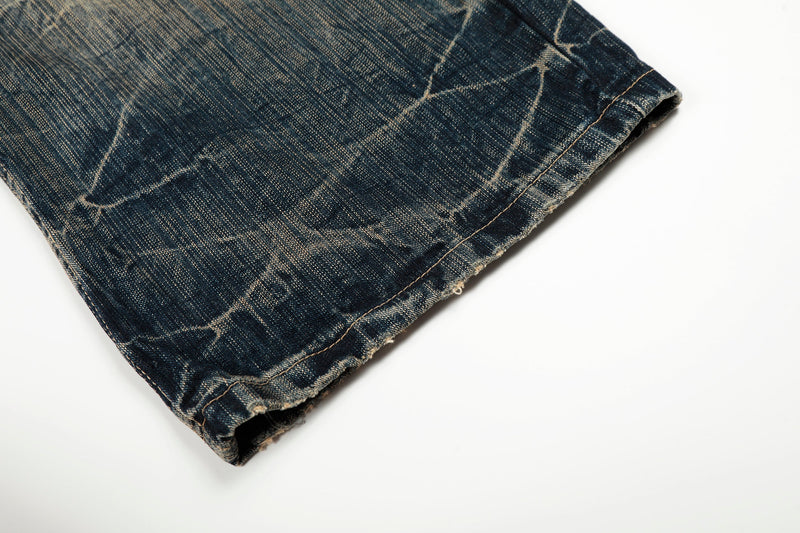 Close-up of the hem on dark washed wide-leg denim pants