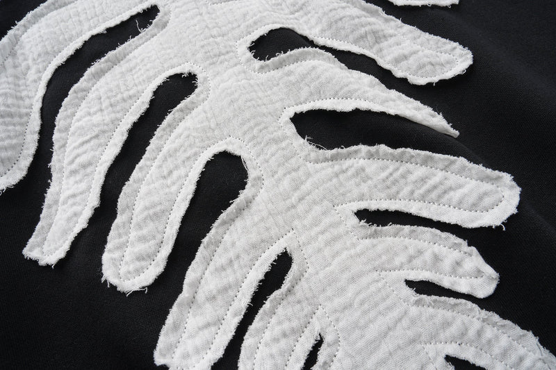 Close-up of white skeleton bone applique on black hoodie back