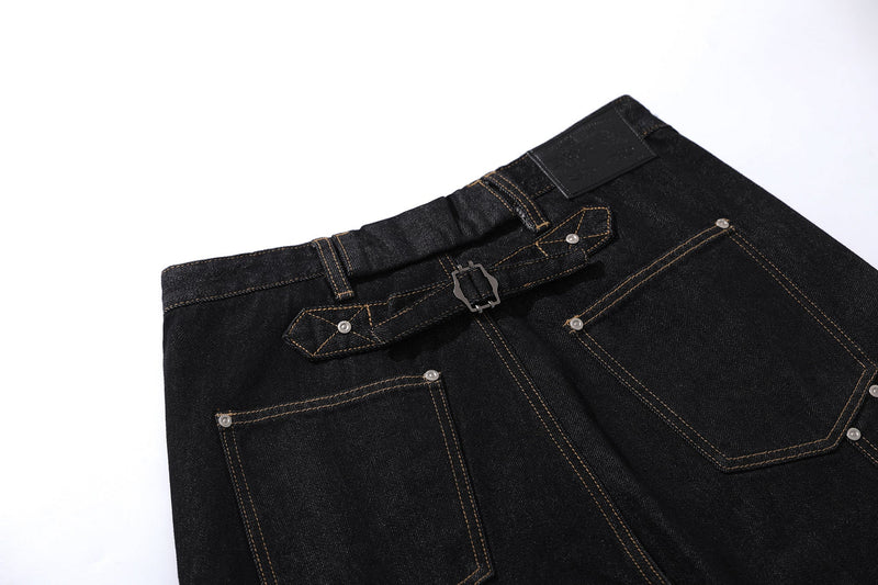 Close-up of back pockets and buckle strap on black wide-leg cargo jeans