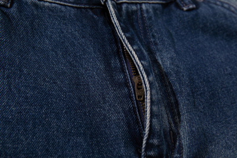 Close-up of zipper fly on dark blue denim jeans