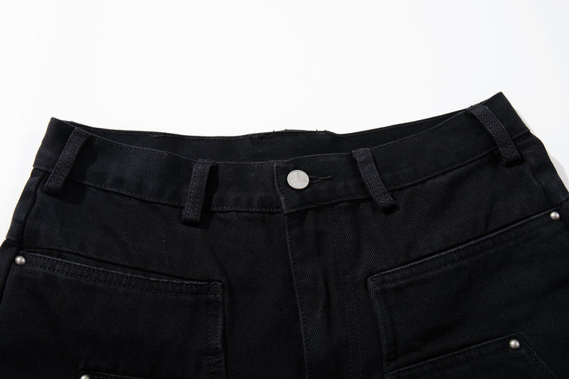 Close-up of the black jean waistband with button closure, belt loops and top pockets