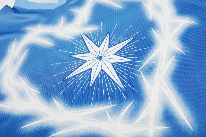 Blue mesh football jersey with a large white starburst graphic and glowing star accents across the fabric