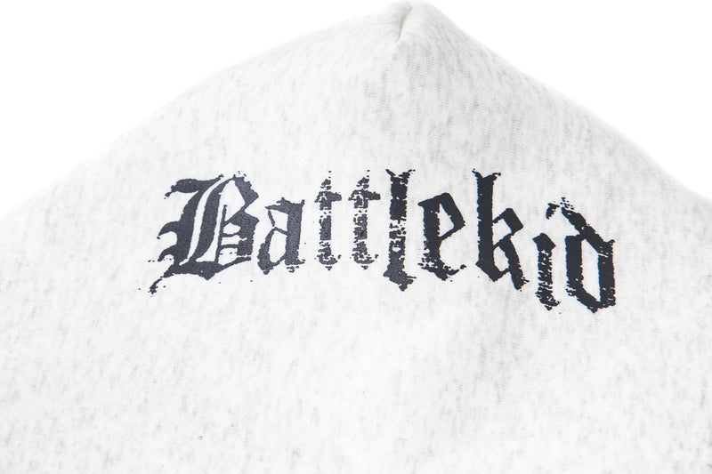 Close-up of hood on white hoodie with distressed black gothic lettering across the back