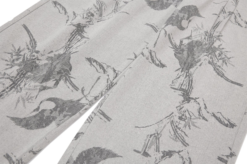 Close-up of both front legs on gray jeans with abstract ink-wash brushstroke print