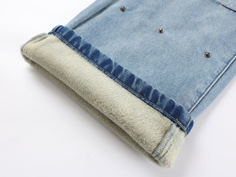 Rolled hem showing cream fleece lining inside blue denim pants