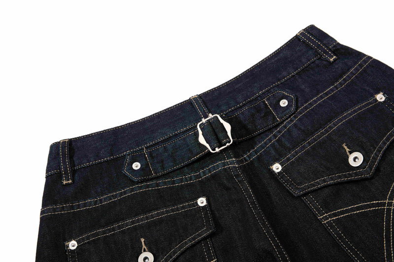 Back waistband of dark wash denim pants with adjustable buckle detail and rear pockets