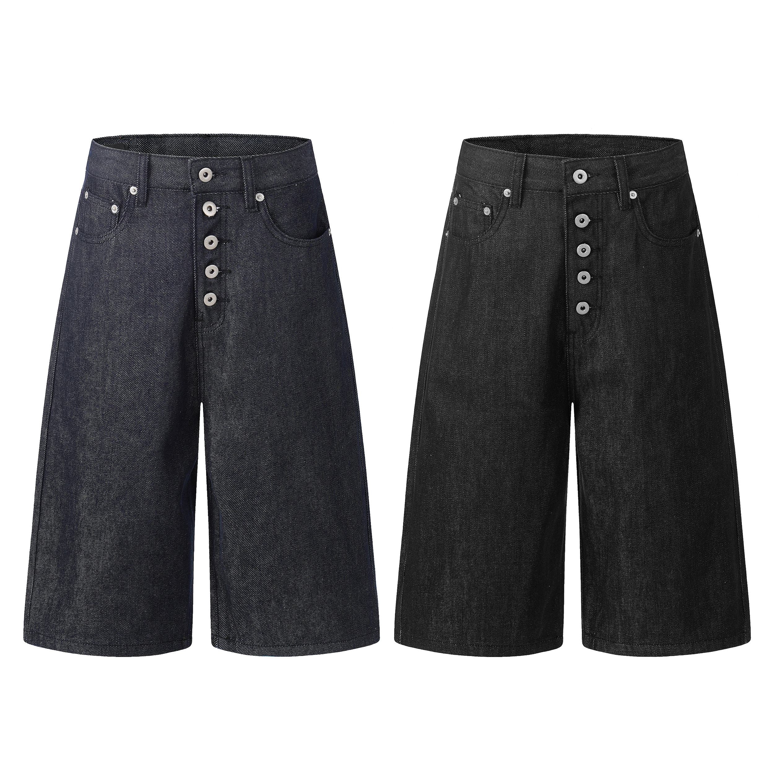 Omirad raw button-fly wide-leg denim jorts in dark indigo and black, front view on white background