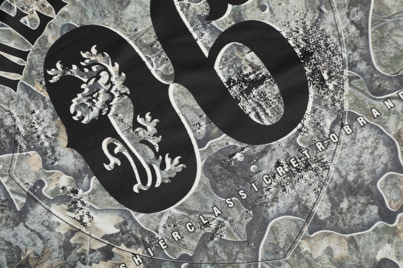 Close-up of back 06 graphic with partial Mershier Classic Retrobrand text on camo jersey