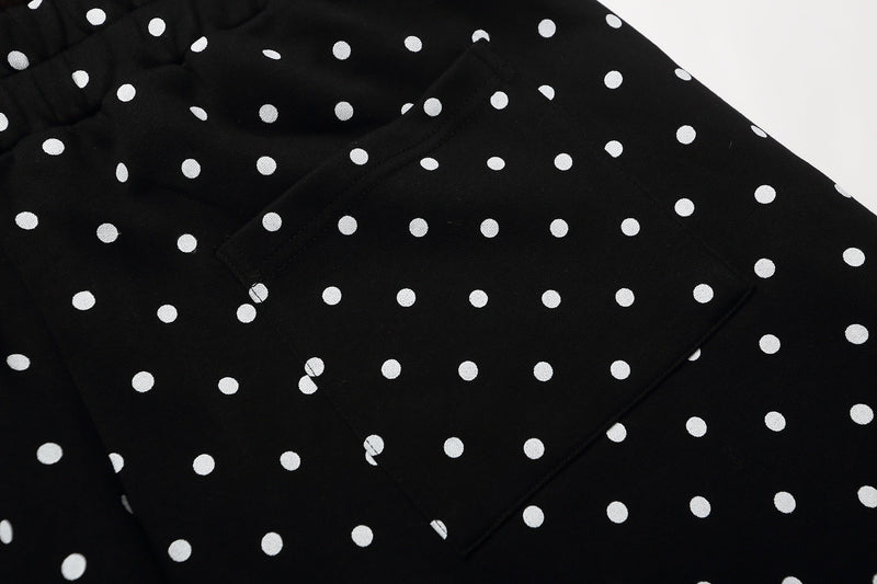 Close-up of black polka dot shorts with a rear pocket seam visible