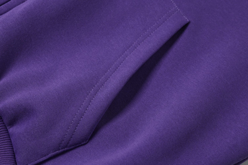 Close-up of purple hoodie front pocket and side seam