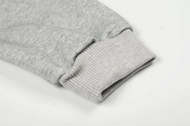 Close-up of light gray hoodie sleeve cuff with ribbed knit trim