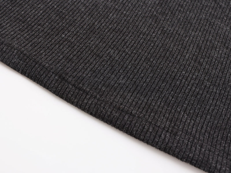Close-up of black ribbed hem with stitched edge