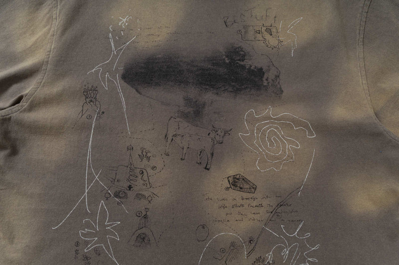 Washed brown tee with abstract sketch graphics, cow doodles, and a vintage distressed streetwear look