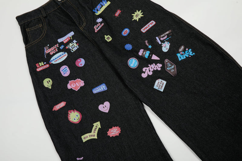 Back view of black wide-leg jeans covered in colorful graphic patches