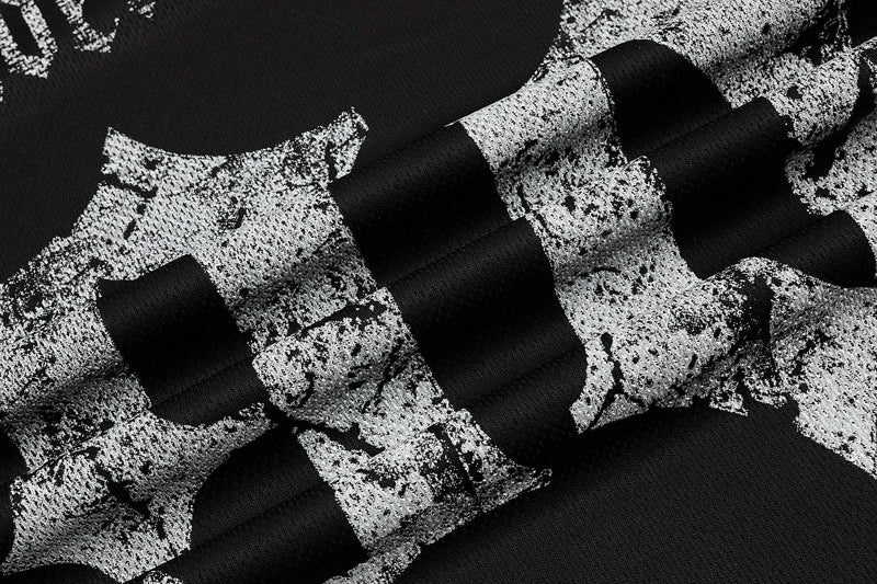 Close-up of black mesh sport tee with distressed white gothic print and bold jersey-inspired texture