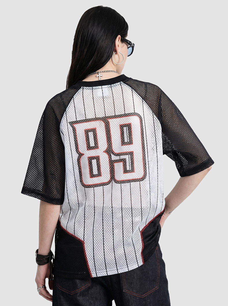 Back view of black mesh jersey T-shirt with pinstripes and large 89 graphic, worn with dark jeans