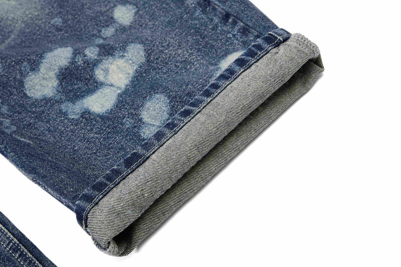 Cuffed hem close-up showing folded blue denim and gray reverse side