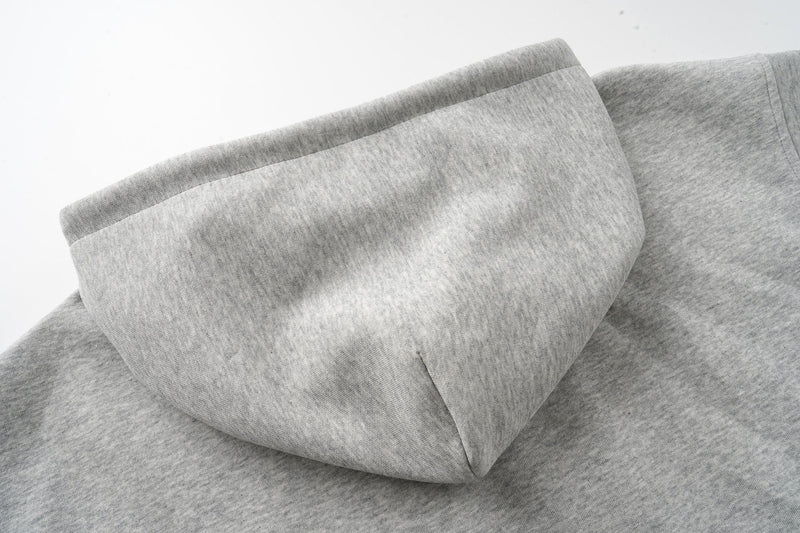 Close-up of heather grey hoodie hood with stitched seam and soft fleece texture