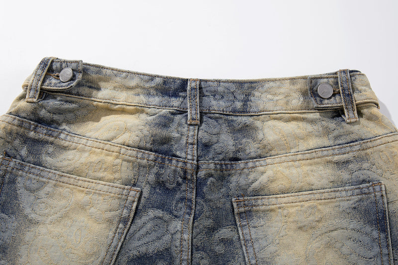 Top waistband detail of faded paisley wide-leg jeans