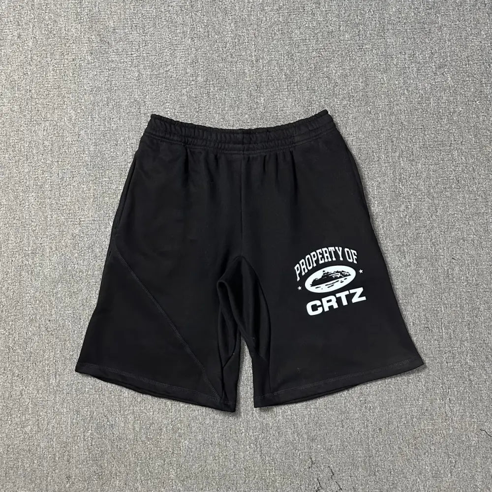 Black Corteiz jogger shorts laid flat, showing white Property of CRTZ graphic print on the left leg