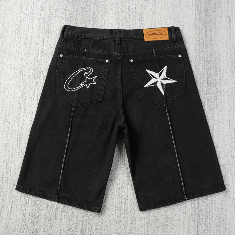 Back view of black Corteiz denim shorts with white embroidered star and C logo on rear pockets