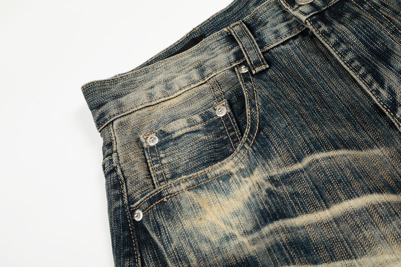 Close-up of the front side pocket and stitched seam on distressed denim pants