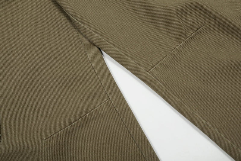 Close-up of olive cargo jeans leg seams and panel stitching