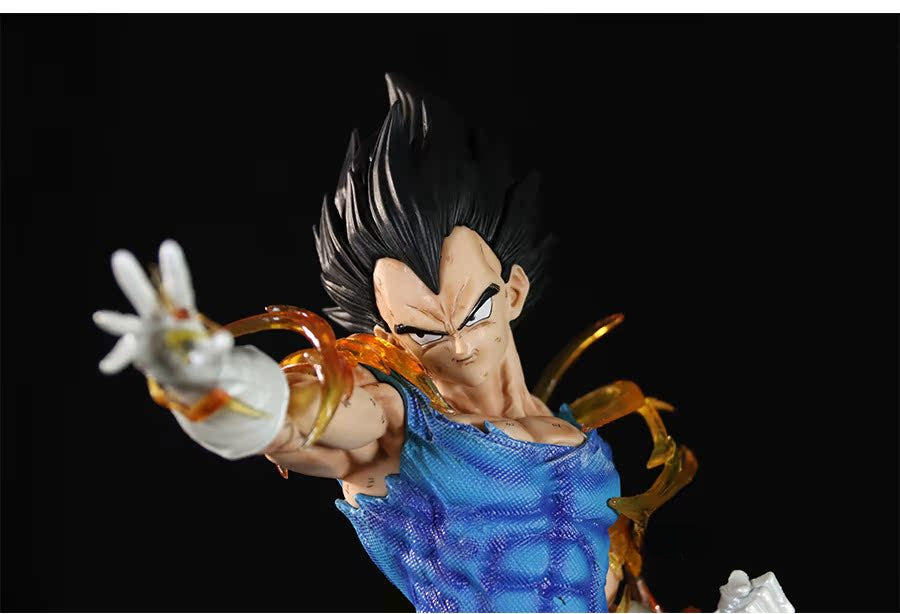 The Seakoff Vegeta Super Saiyan Collectible Figure, 45cm from Dragon Ball Z, features interchangeable heads and glowing effects. It depicts Vegeta with spiky black hair in a dynamically posed torn blue shirt and white gloves against a stark black background, capturing his Super Saiyan essence.