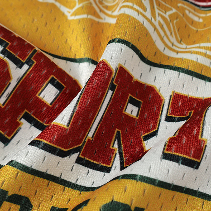 Close-up of yellow and white mesh football jersey fabric with bold red varsity lettering and black trim
