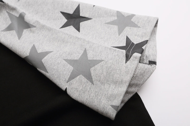 Gray raglan tee sleeve with large star print and visible stitched hem on soft cotton fabric