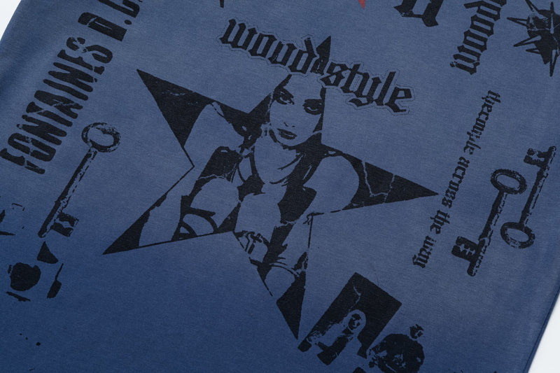 Close-up of a blue vintage graphic tee with black star and gothic text print in an oversized streetwear style