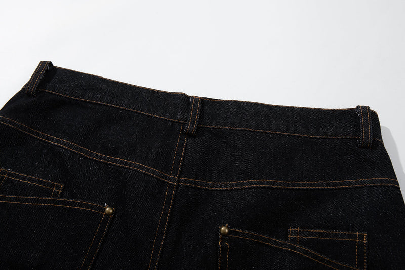 Close-up of the back waistband and upper pocket area on black denim pants