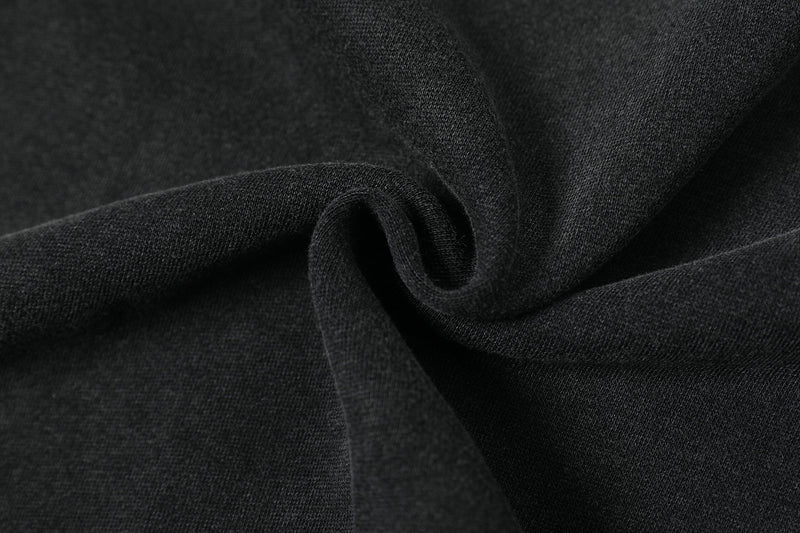 Close-up of black washed fabric texture with soft draped folds