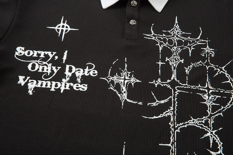 Front chest view of black polo shirt with white text and thorny white graphic print