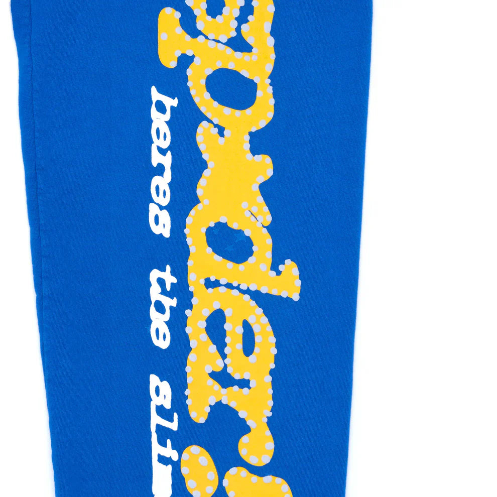 Sp5der Sweatpants – Unisex blue cotton sweatpants with a yellow “spider” side logo and star print, perfect for a bold streetwear joggers look.