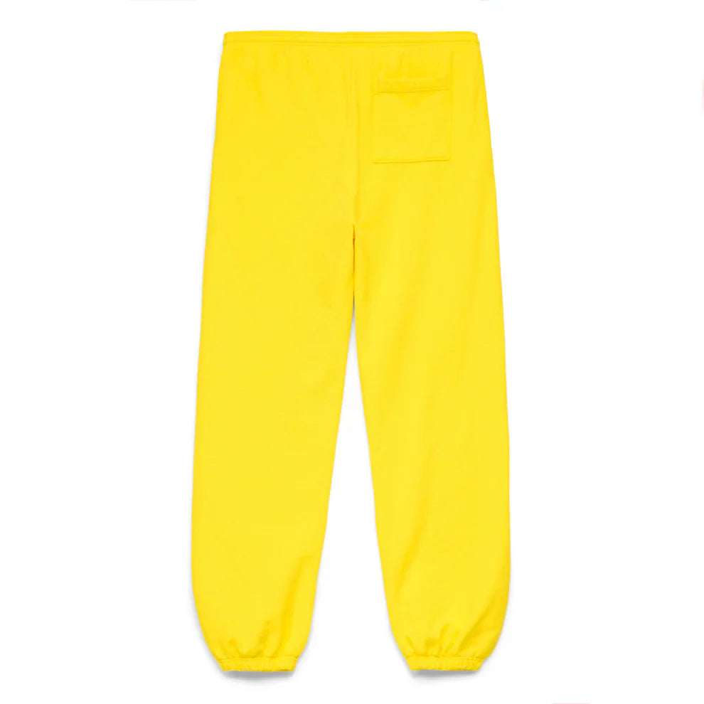 Sp5der Sweatpants – Unisex yellow cotton sweatpants with front logo print, elastic waistband and cuffs, and a single upper-right pocket, shown from the back and laid flat on a white background.
