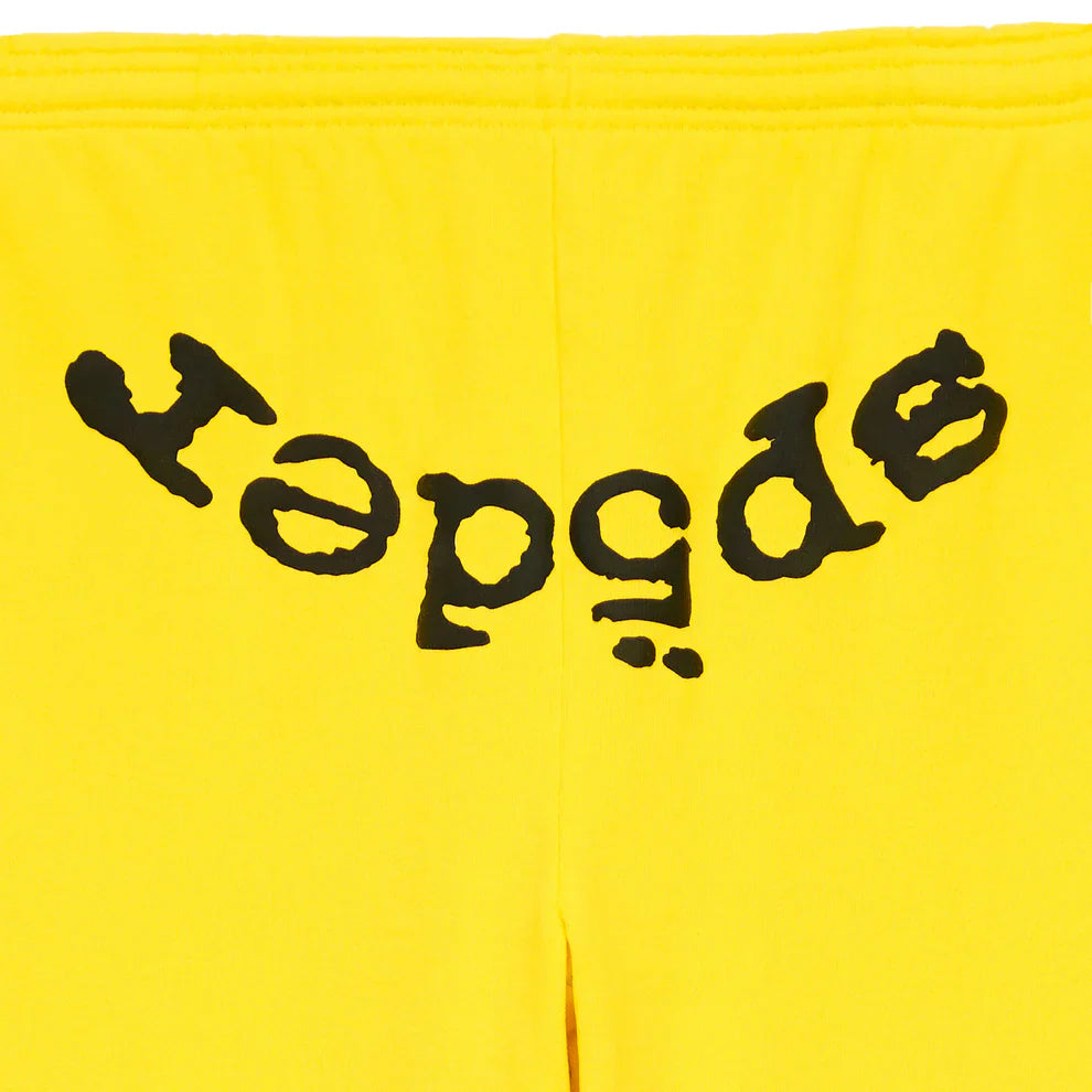 Unisex Sp5der Sweatpants in yellow cotton, featuring a bold front logo print—a standout streetwear piece.