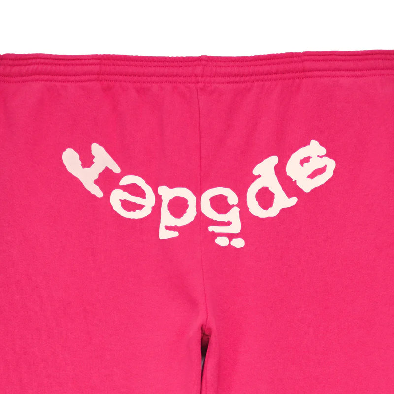 The Sp5der Sweatpants are unisex pink cotton joggers featuring a bold front logo print, combining comfort and standout streetwear style.